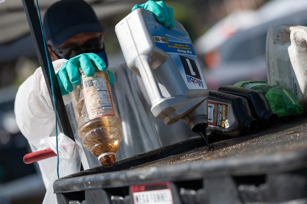 photo of a man pouring hazardous liquid into a container