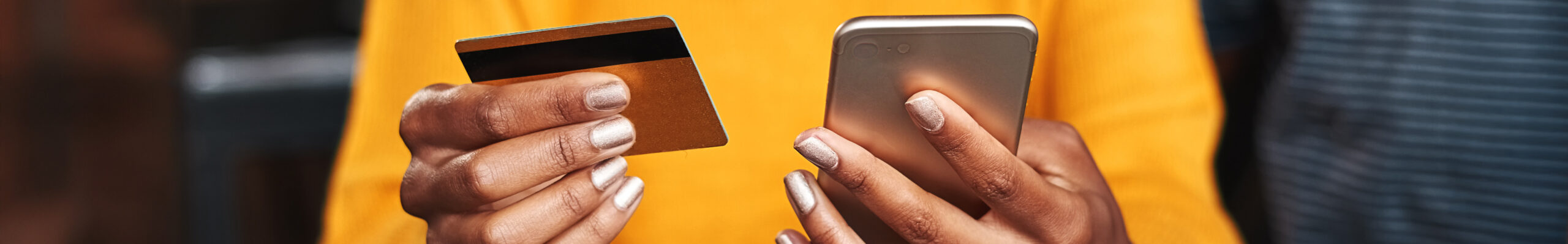 woman holding phone and credit card